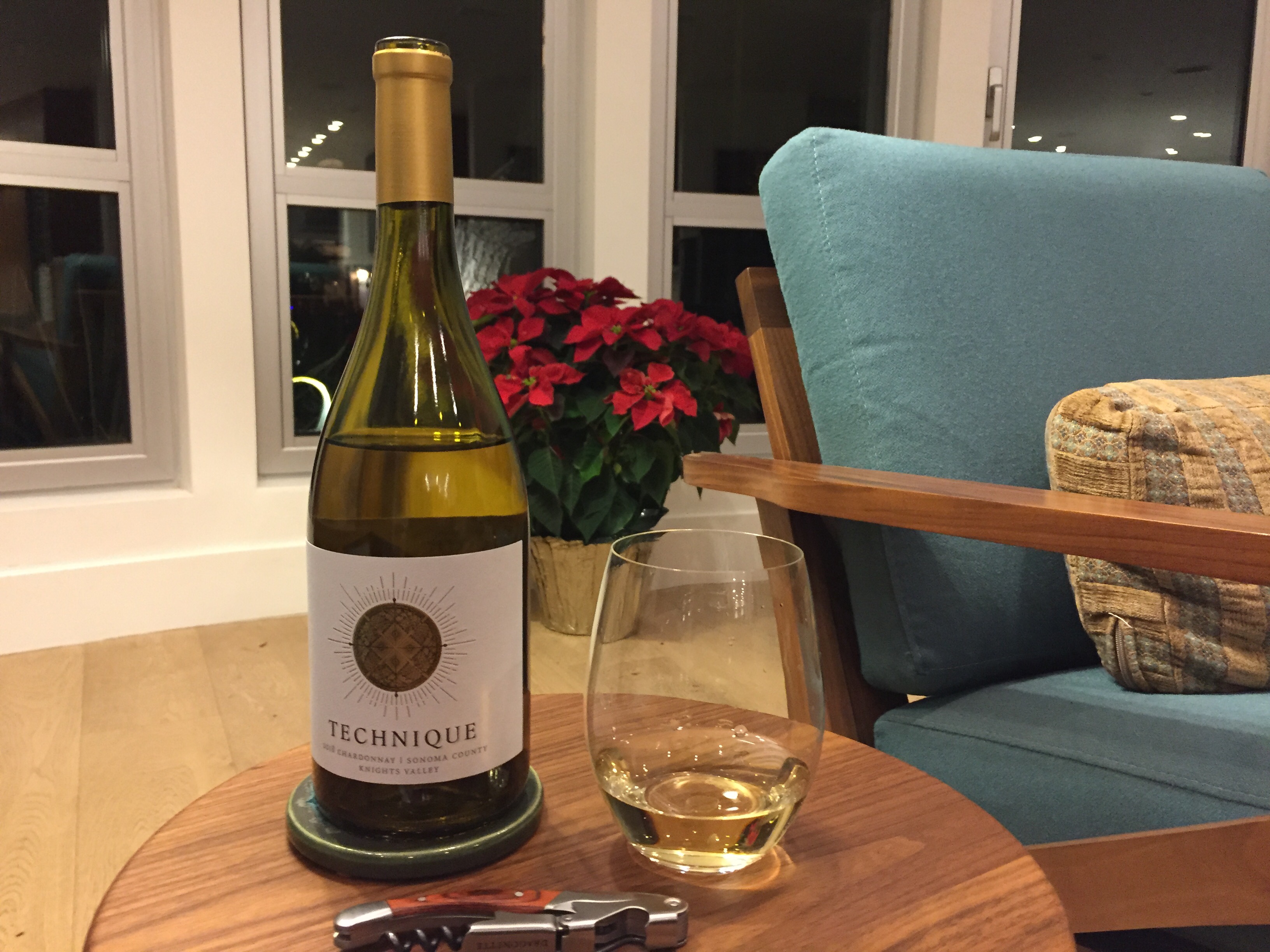 Bottle and glass of Technique Chardonnay from Costco.