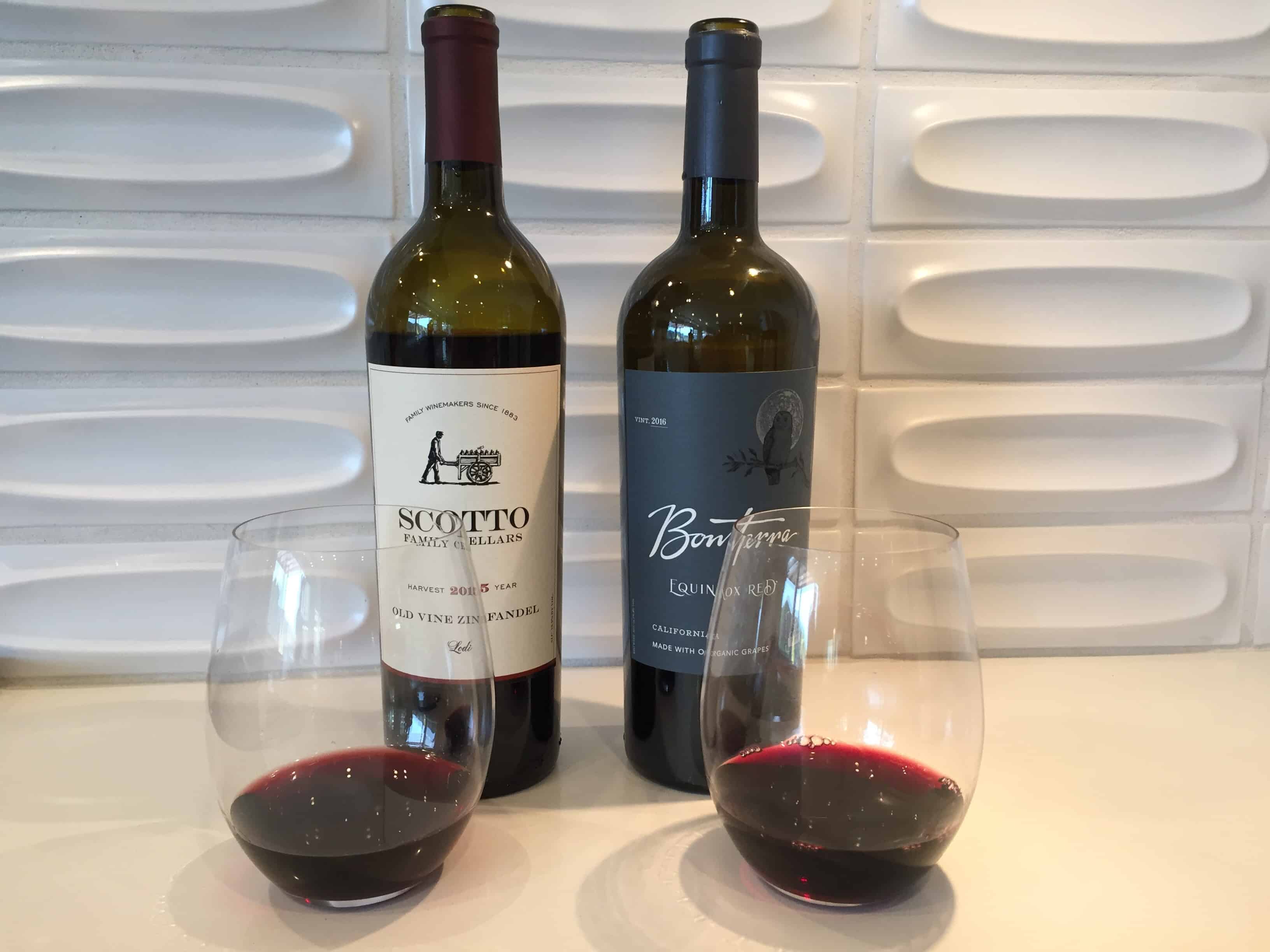 Bottles and glasses of Scotto Zinfandel and Bonterra red blend