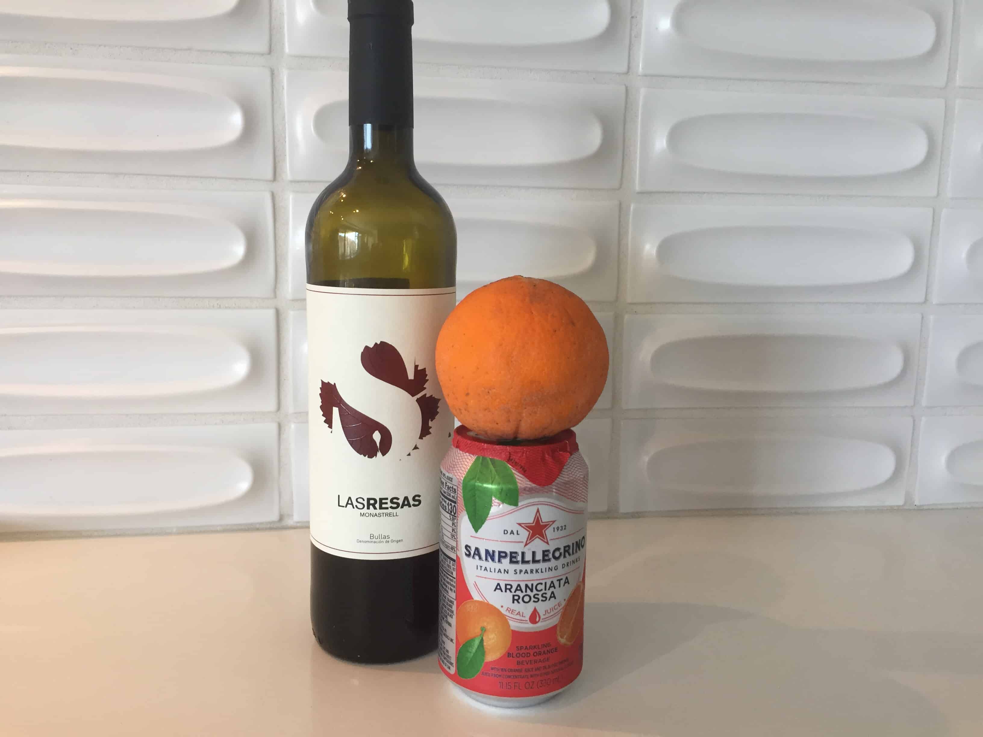 Bottle of Las Resas 2017 Monastrell and can of San Pellegrino blood orange soda.