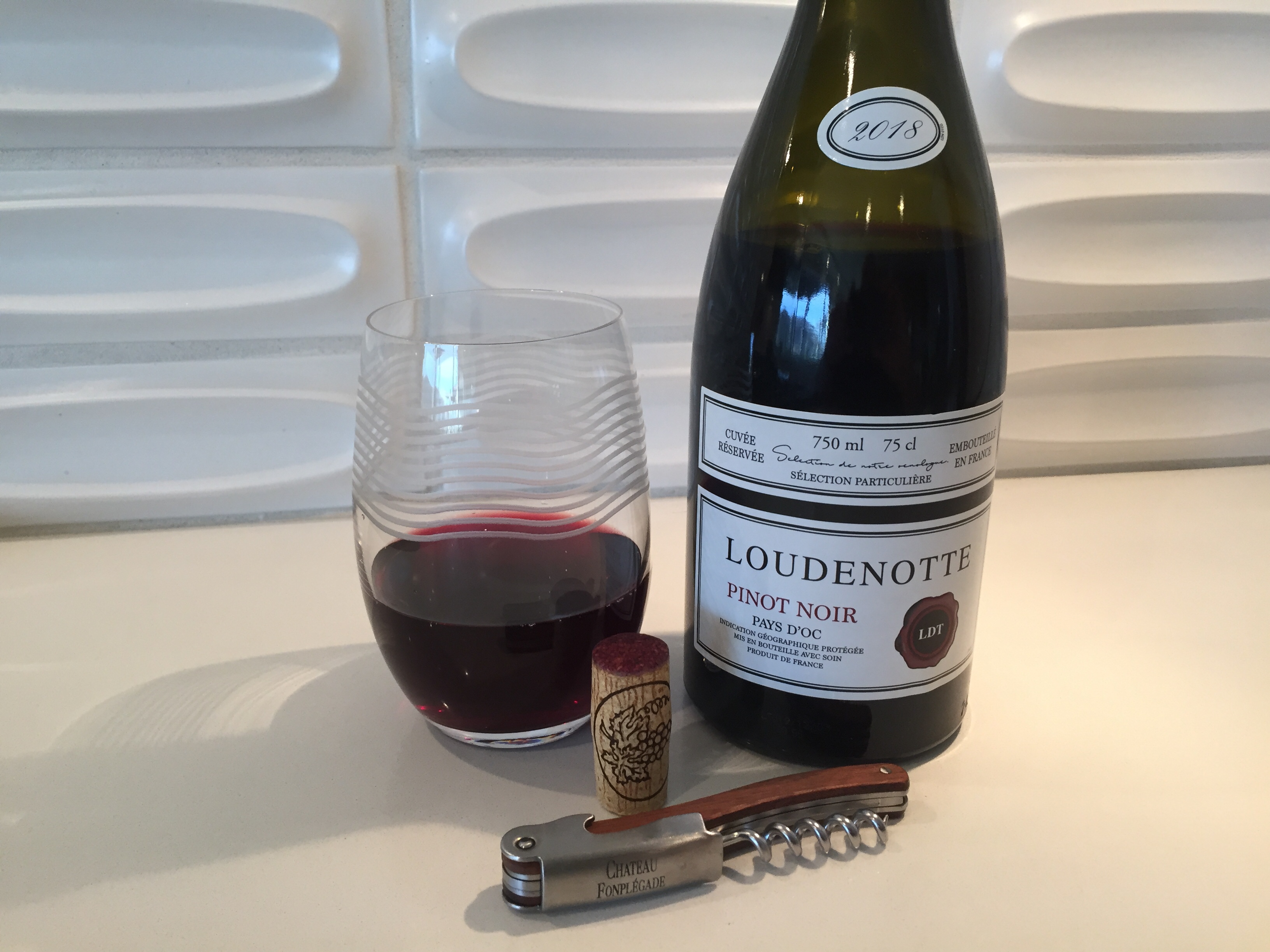 Bottle and glass of 2018 Loudenotte Pinot Noir from Trader Joe's