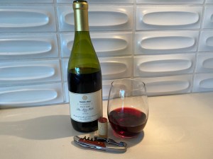 Bottle and glass of 2020 Trader Joe's Reserve Pinot Noir Lot #229, Santa Rita Hills