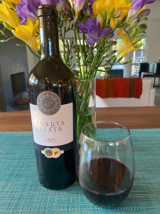 Bottle and glass of 2015 Puerta de Plata red blend wine from Trader Joe's