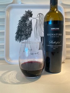 Label and glass of 2021 Kirkland Signature Cabernet Sauvignon, Rutherford, Napa Valley, California