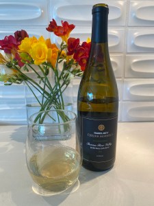 Bottle and glass of 2022  Trader Joe's Grand Reserve Chardonnay Lot #128, Russian River Valley