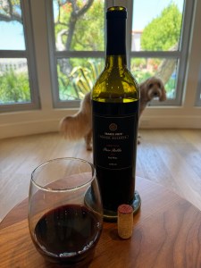 Bottle and glass of 2021 Trader Joe's Grand Reserve Meritage, Lot# 129