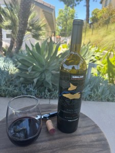 Bottle and glass of 2021 Kirkland Signature Cabernet Sauvignon, Suscol Vineyard, Napa Valley